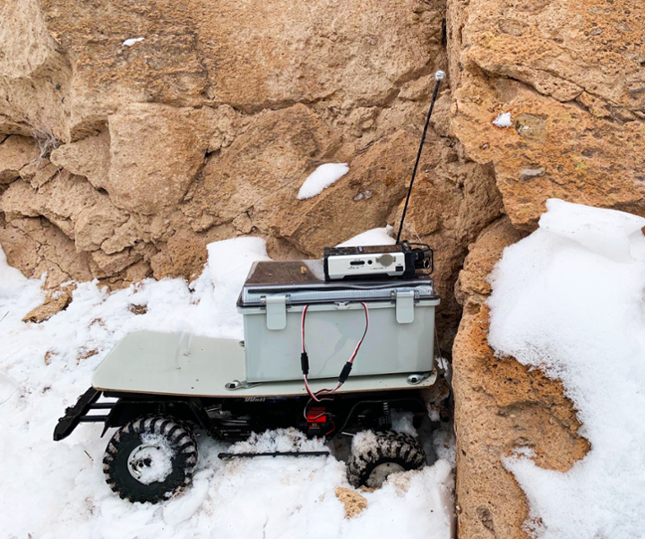 photo: Brutus the robot outside in the snow, on a cliffside.