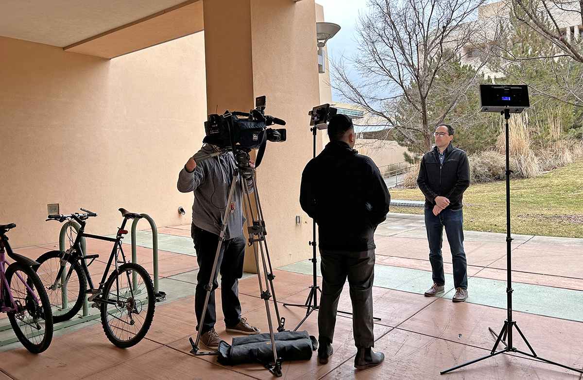 photo: Lights, camera, action: Nick Ferenchak gives an interview to a local TV station recently outside the Centennial Engineering Center.   