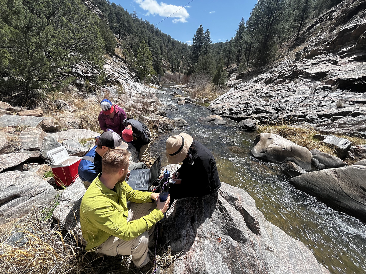 photo: researchers working in the middle of a river